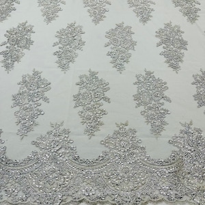 Metallic silver corded embroider with sequins on a mesh lace fabric-prom-sold by the yard.