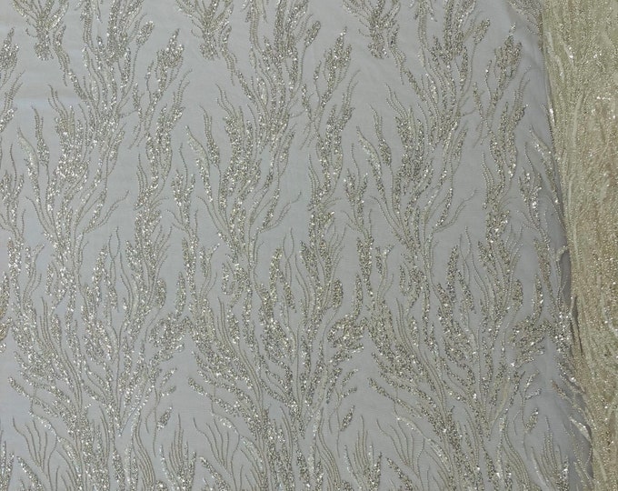Off white/Clear Fancy Design Embroider and heavy beading on a mesh lace-sold by the yard.