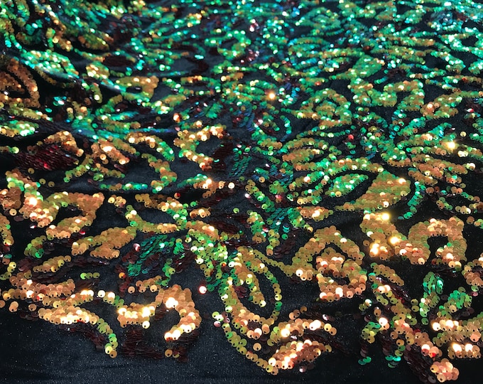 Orange, green iridescent sequins flip two tone floral design on a black stretch velvet, Sold by the yard.