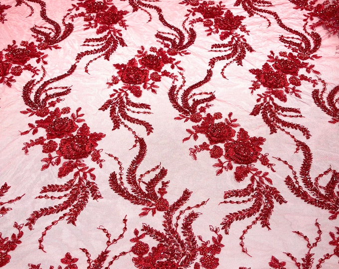 Red flowers embroider and heavy beaded on a mesh lace fabric-sold by the yard.