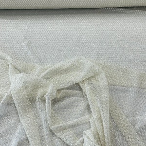 Ivory heavy beaded princess design embroider with beads and sequins on a glitter mesh lace-sold by yard.