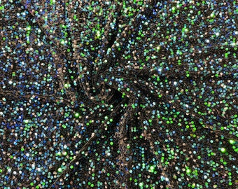 Green Iridescent economic all over shiny sequins on a 2 way stretch black velvet , sold by the yard.