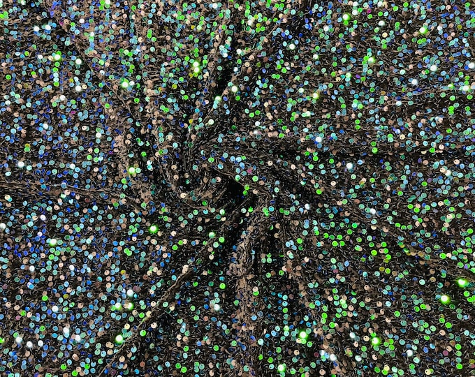 Green Iridescent economic all over shiny sequins on a 2 way stretch black velvet , sold by the yard.