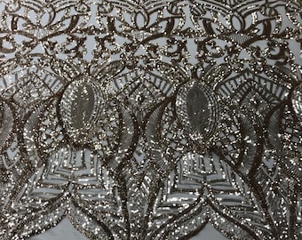 Gold royalty design embroider with shiny sequins on a 4 way stretch power mesh-sold by the yard.