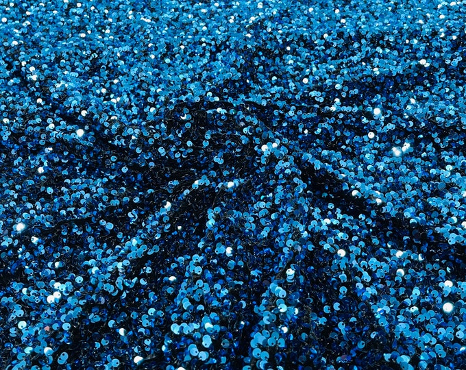 Turquoise 5mm sequins on a stretch black velvet 2-way stretch, sold by the yard.