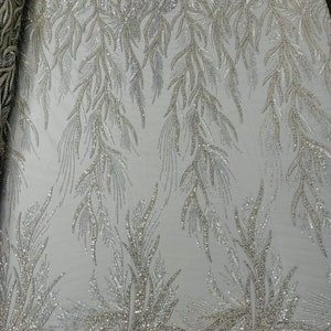 Silver Fiesta Design Embroider and heavy beading on a mesh lace-sold by the yard.