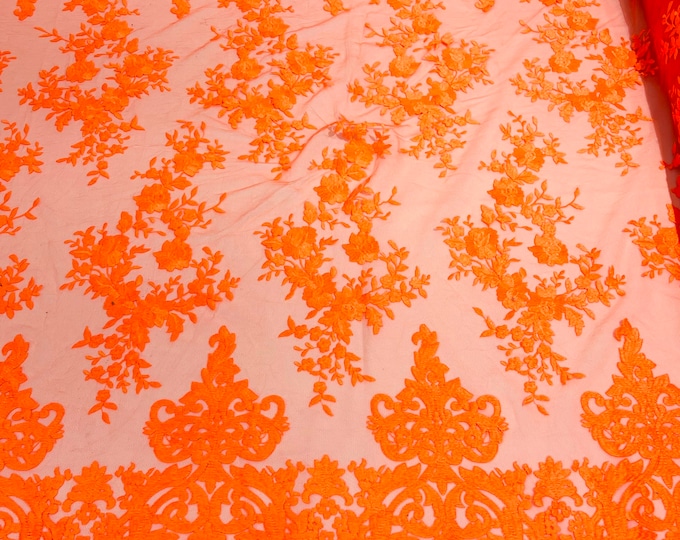 Neon Orange flowers flat lace embroider on a 2 way stretch mesh sold by the yard.