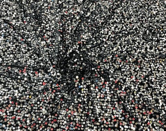 Silver economic all over shiny sequins on a 2 way stretch black velvet , sold by the yard.