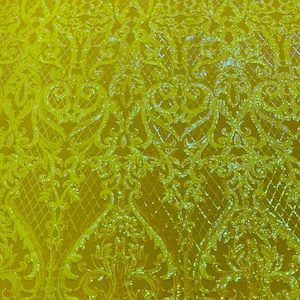 May include: Yellow sequined fabric with a floral pattern. The sequins are small and create a shimmering effect.
