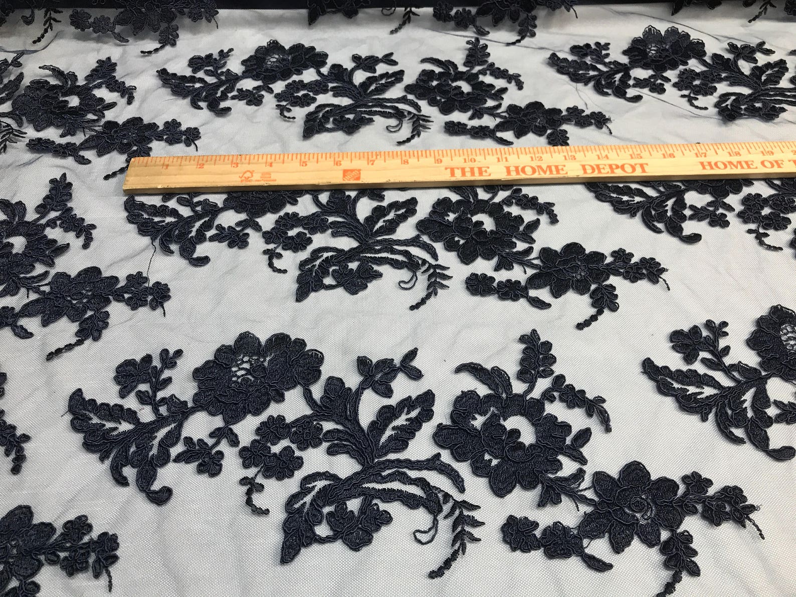 NAVY BLUE FLORAL DESIGN WITH CORD EMBROIDERY ON A MESH LACE-SOLD BY YARD.