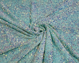 Clear iridescent 5mm sequins on a mint green stretch velvet 2-way stretch, sold by the yard.