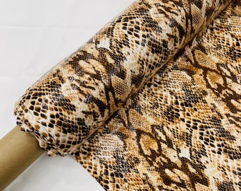 Tan/Black glossy python snake print on a 2 way stretch spandex/58” wide/sold by the yard.