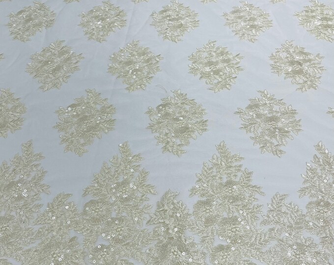 Cream Floral corded embroider with sequins on a mesh lace fabric-sold by the yard.