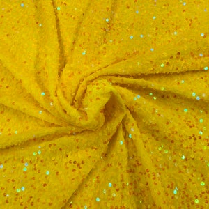 Clear Iridescent economic all over shiny sequins on a 2 way stretch Yellow velvet , sold by the yard.