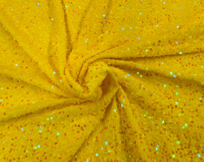 Clear Iridescent economic all over shiny sequins on a 2 way stretch Yellow velvet , sold by the yard.