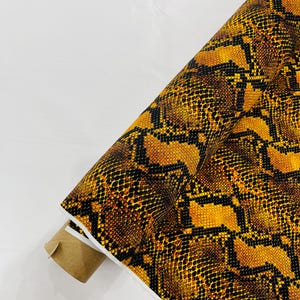 Gold/Black python snake print on a 4 way stretch nylon spandex/58” wide/sold by the yard.