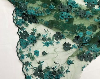 May include: Green floral lace fabric with a scalloped edge. The lace features 3D flowers with pearl accents.