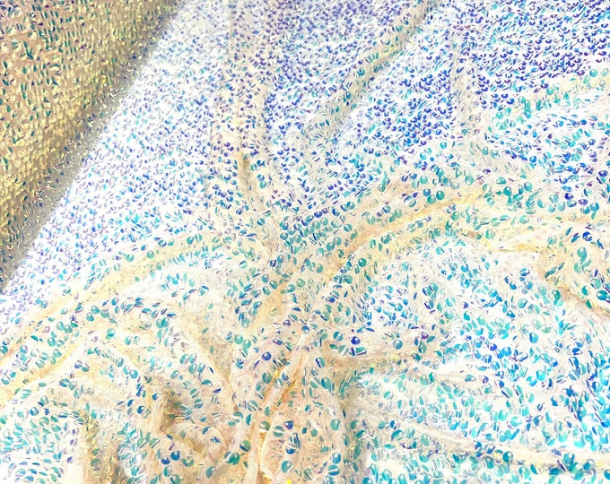 Aqua Clear iridescent mini round paillette sequins embroidered on a nude stretch mesh, sold by the yard.