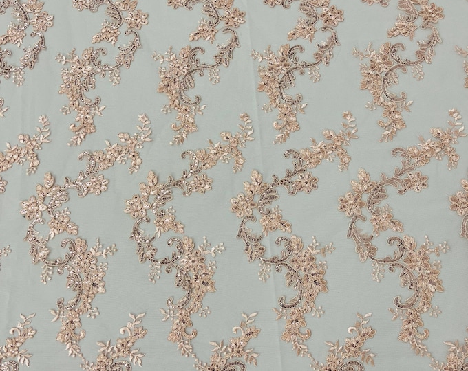 Blush peach flower lace corded and embroider with sequins on a mesh-Sold by the yard.