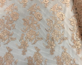 Peach floral design embroider and corded on a mesh lace fabric-sold by the yard.
