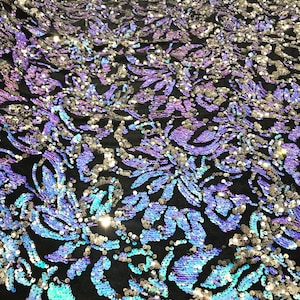 Aqua blue iridescent, silver sequins flip two tone floral design on a black stretch velvet, Sold by the yard.