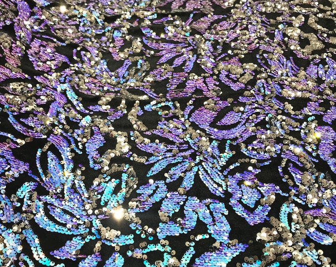 Aqua blue iridescent, silver sequins flip two tone floral design on a black stretch velvet, Sold by the yard.