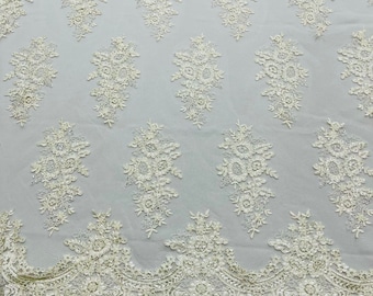 Ivory corded embroider with sequins on a mesh lace fabric-prom-sold by the yard.