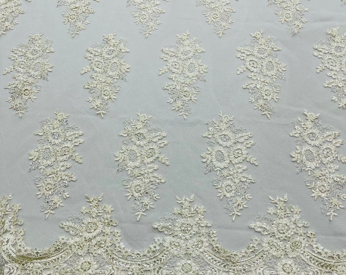 Ivory corded embroider with sequins on a mesh lace fabric-prom-sold by the yard.