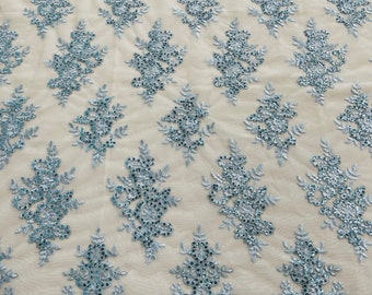 Light blue flower lace corded and embroider with sequins on a mesh fabric- Sold by the yard.