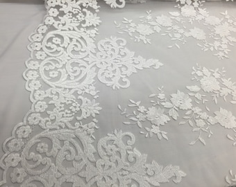 White flowers embroider on a 2 way stretch mesh lace. Wedding/Bridal/Prom/Nightgown fabric-apparel-fashion-dresses-Sold by the yard.