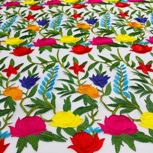Maria multi color Mexican Sarape floral design embroider on a Ivory mesh lace-sold by the yard.
