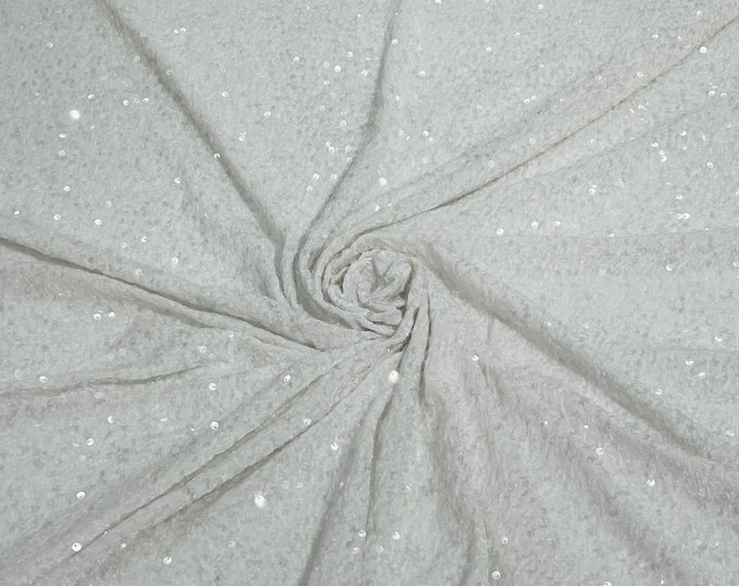 Clear 5mm sequins on a white stretch velvet 2-way stretch, sold by the yard.