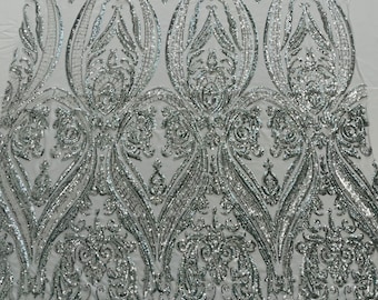 Silver Empire damask design with sequins embroider on a white 4 way stretch mesh fabric-sold by the yard.
