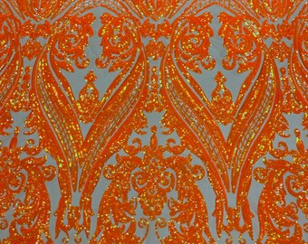 Neon orange iridescent shiny sequin damask design on a Nude 4 way stretch mesh-sold by the yard.