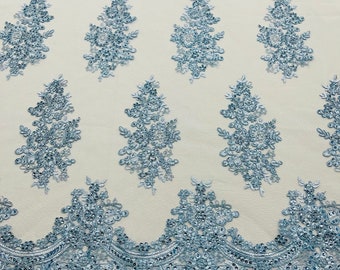 Light blue corded embroider with sequins on a mesh lace fabric-prom-sold by the yard.