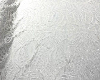 White royalty design embroider with shiny sequins on a 4 way stretch power mesh.