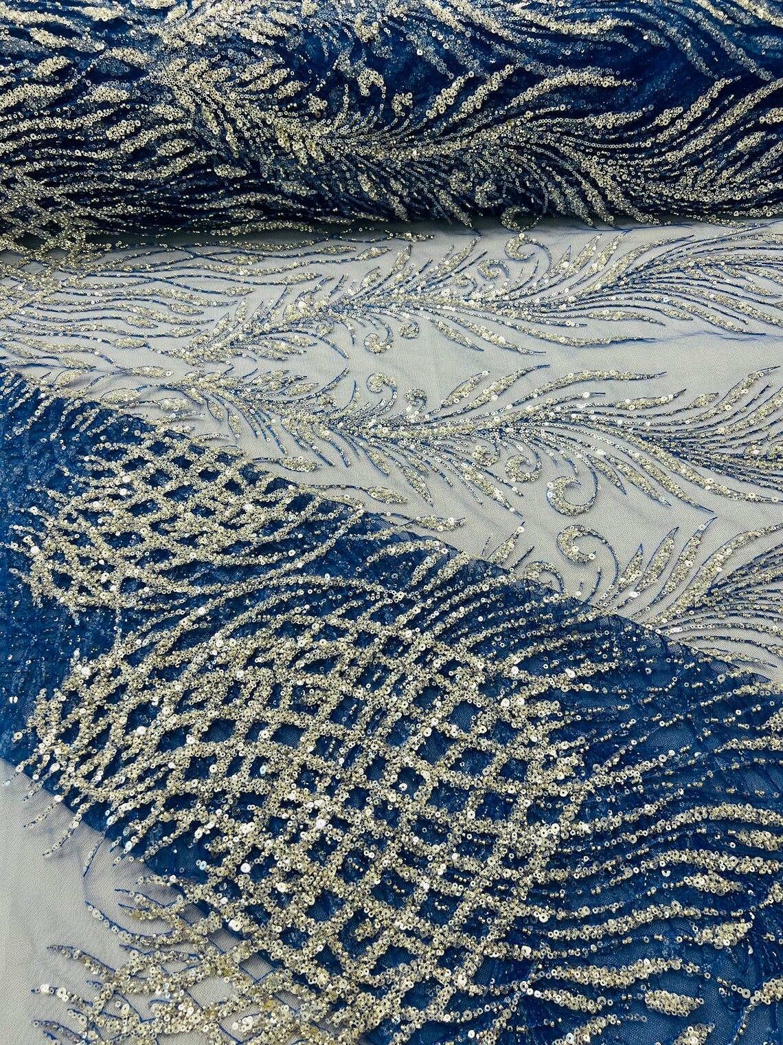 ROYAL BLUE DIVA DESIGN EMBROIDERY WITH HEAVY BEADED ON A MESH-SOLD BY YARD.