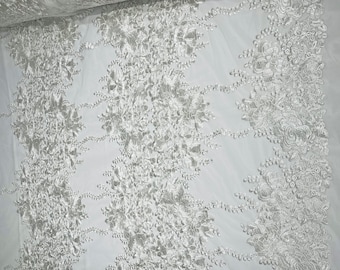 Ivory roses floral design embroider on a off white mesh lace fabric-sold by the yard.