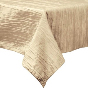 May include: A beige tablecloth with a subtle textured pattern. The tablecloth is made of a soft, wrinkle-resistant fabric.