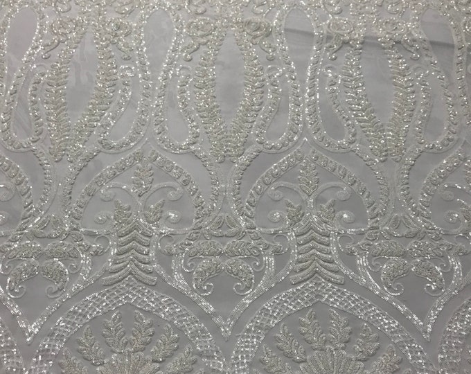 White diva design embroider with sequins on a 4 way stretch power mesh-sold by the yard.