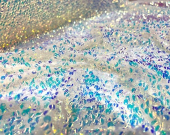 Aqua Clear iridescent mini round paillette sequins embroidered on a white stretch mesh, sold by the yard.