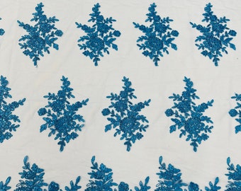 Turquoise corded lace floral embroider sold by the yard.