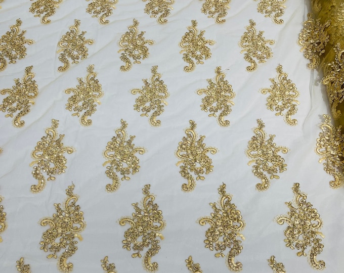 Gold Metallic floral design embroidery on a mesh lace with sequins and cord-sold by the yard.