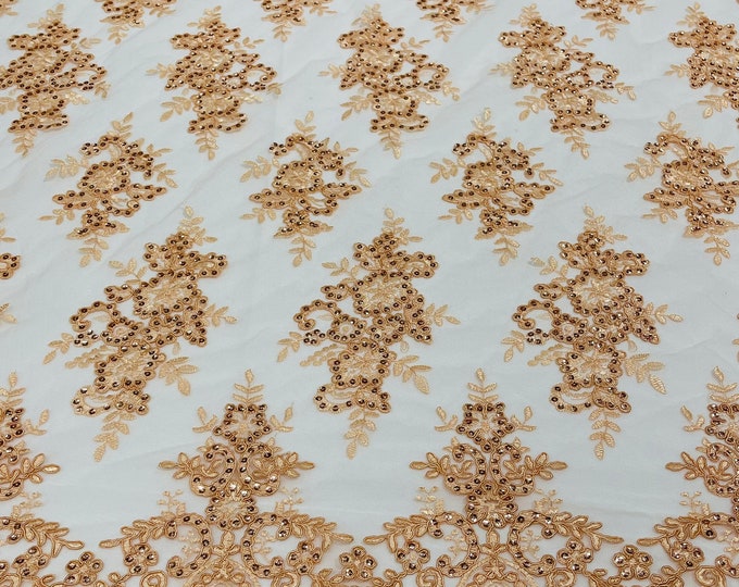 Peach corded flowers embroider with sequins on a mesh lace fabric-sold by the yard.