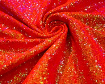 Naranja iridiscente: mini lentejuelas brillantes sobre tela de spandex elástica en 4 direcciones. Se vende cortada a medida.