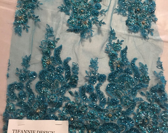 Teal flowers embroider and heavy beaded on a mesh lace fabric-sold by the yard-