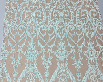 Aqua iridescent shiny sequin damask design on a Nude 4 way stretch mesh-sold by the yard.