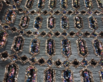 Black/blue iridescent Jewel sequin design on a black 4 way stretch mesh fabric -sold by the yard.