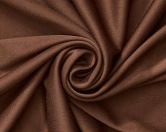 Tejido de poliéster de punto interlock, elástico mecánico, color marrón. Se vende cortado a medida.