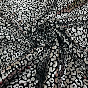 Silver metallic leopard  print on a Black stretch nylon spandex tricot/milliskin -sold by the yard.